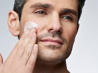 Man applying skincare