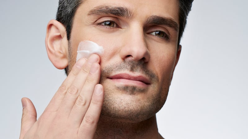 Man applying skincare