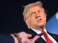 U.S. President Donald Trump (L) talks with reporters