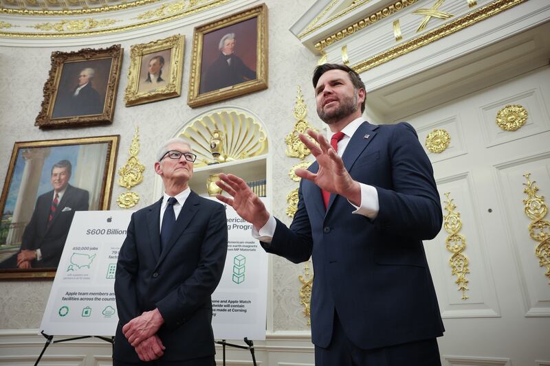 U.S. VIce President JD Vance (R) speaks next to Apple CEO Tim Cook (L) during an event in the Oval Office, where he insisted he was not hosting a strategy meeting to discuss the Epstein files.