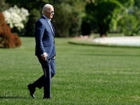 Joe Biden has stopped walking alone across the South Lawn at the White House to board Marine One.