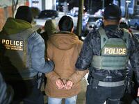 NEW YORK, NY - JANUARY 28: Law enforcement walk with Leonardo Fabian Cando Juntamay as he was detained in the Bronx during ICE led operations to apprehend illegal immigrants on Tuesday January 28, 2025 in New York, NY. (Photo by Matt McClain/The Washington Post via Getty Images)
