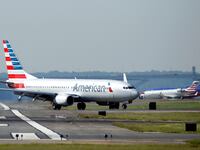 An American Airlines jet taxis on the runway.