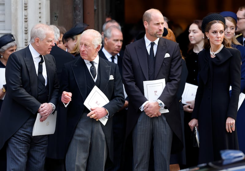 King Charles speaks to Prince Andrew, while Prince William and Catherine, Princess of Wales, look away.