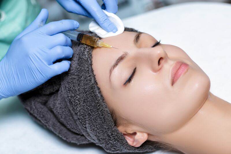 procedure Plasmolifting injection. plasma injection into the skin of the forehead of the patient