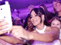Photo of Jessel Taank taking a selfie with fans at BravoCon.