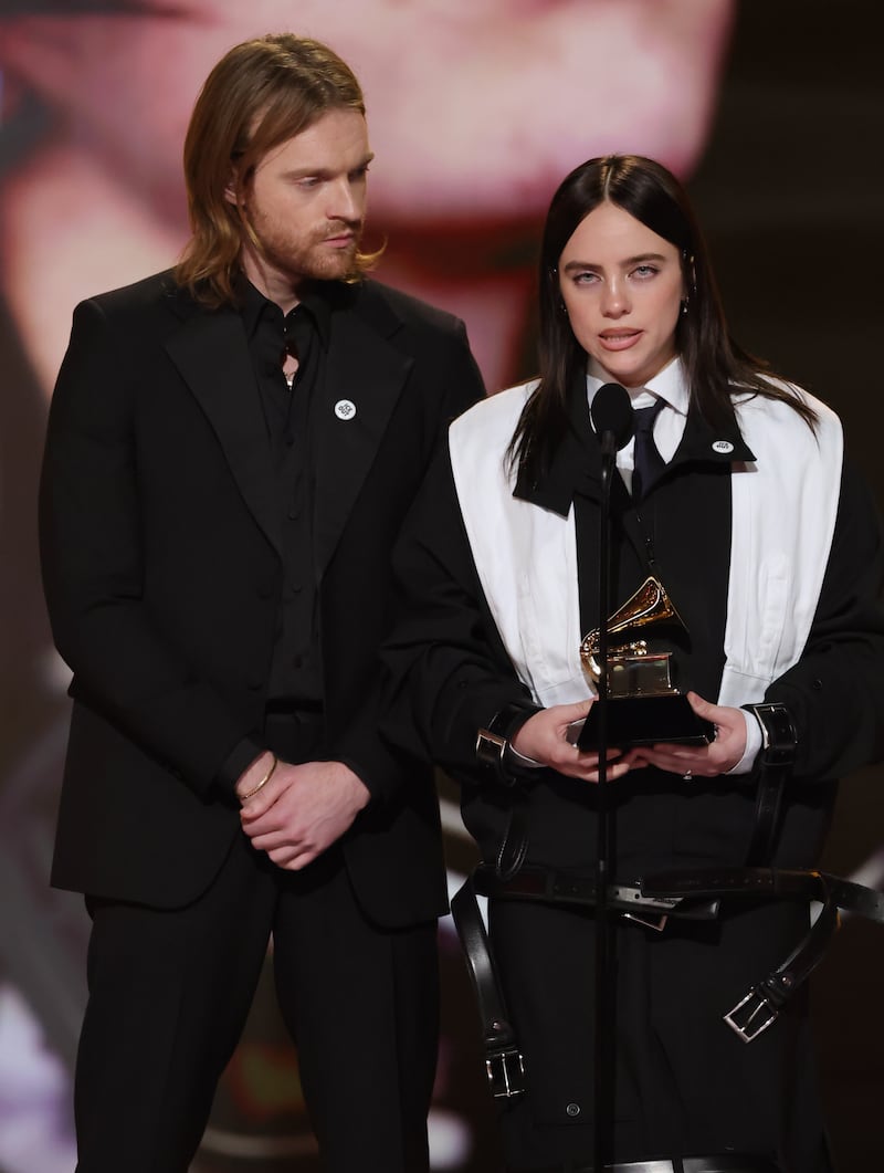 LOS ANGELES, CALIFORNIA - FEBRUARY 01: (L-R) Finneas O'Connell and Billie Eilish accept the Song Of The Year award for “WILDFLOWER” onstage during the 68th GRAMMY Awards at Crypto.com Arena on February 01, 2026 in Los Angeles, California. (Photo by Kevin Winter/Getty Images for The Recording Academy)