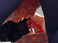 BUTLER, PENNSYLVANIA - JULY 13: Secret Service tend to republican presidential candidate former President Donald Trump onstage at a rally on July 13, 2024 in Butler, Pennsylvania.