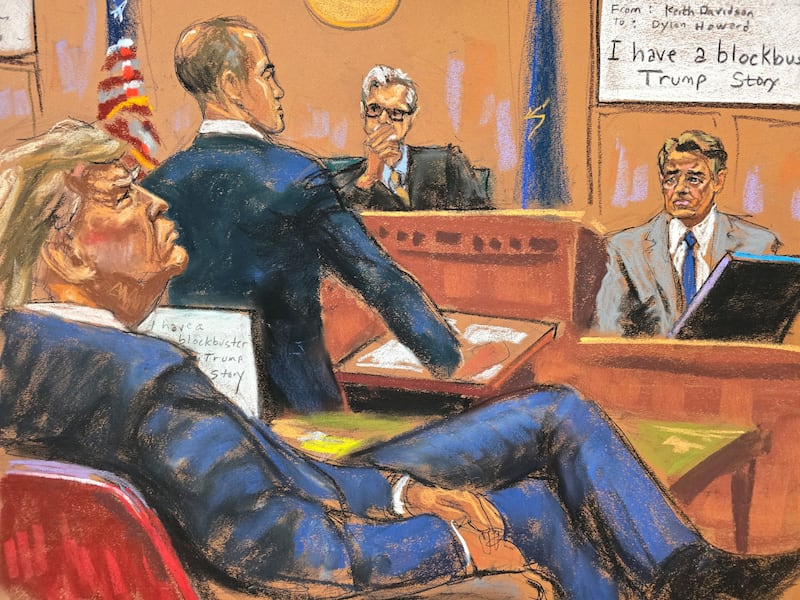 Former U.S. President Donald Trump watches as lawyer Keith Davidson, who represented former Playboy model Karen McDougal, is cross examined by defense attorney Emil Bove during Trump's criminal trial.