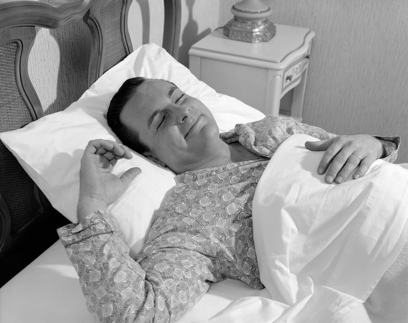 UNITED STATES - CIRCA 1960s: Man in bed, in tranquil sleep.