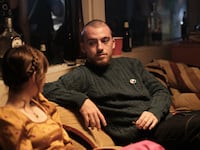 Maude Apatow and Angus Cloud sit together on Euphoria.