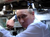 Russia's Prime Minister Vladimir Putin sits inside a T-90AM tank during a visit to an arms exhibition in the Urals town of Nizhny Tagil, on September 9, 2011. AFP PHOTO/ RIA-NOVOSTI POOL/ ALEXEY DRUZHININ (Photo credit should read ALEXEY DRUZHININ/AFP via Getty Images)
