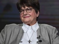 Sister Helen Prejean sitting on a stage.