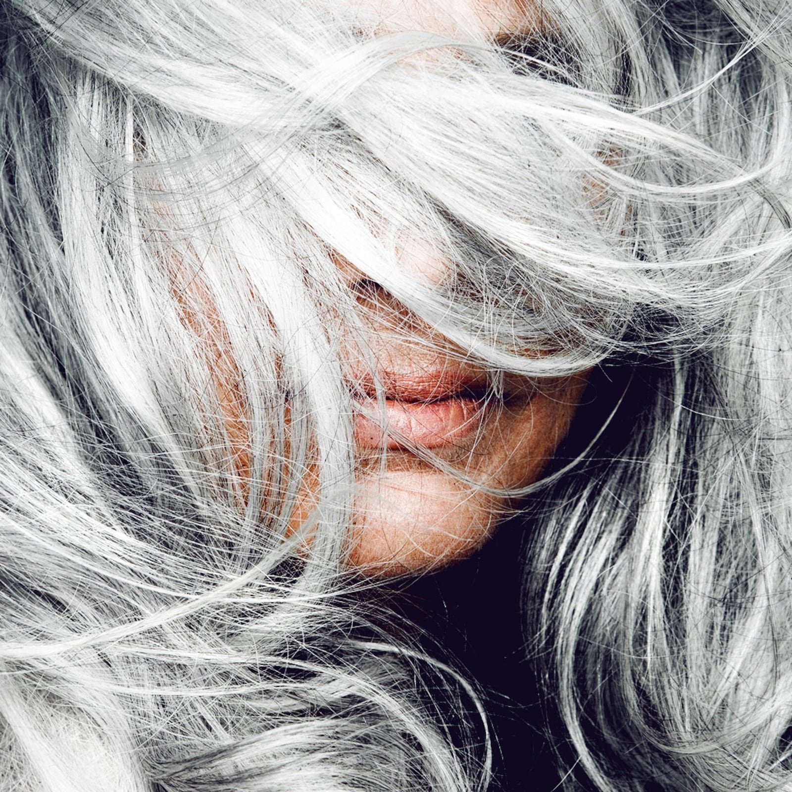 Woman tossing her silver hair.
