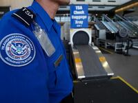 TSA agent at airport screening checkpoint.