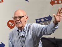 James Carville waves to the audience during a speaking engagement.