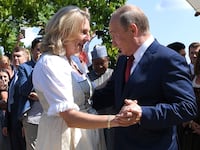 Austria's then-Foreign Minister Karin Kneissl dances with Russia's President Vladimir Putin at her wedding in Gamlitz, Austria, August 18, 2018.