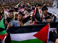 Students demonstrate during a Pro-Palestinian protest during the University of Michigan's spring commencement ceremony on May 4, 2024 at Michigan Stadium in Ann Arbor, Michigan.