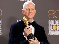 A picture of Ryan Murphy poses holding a Golden Globe award. Murphy reportedly threatened to sue a strike captain of the Writer’s Guild of America over accusations that Murphy was engaging in anti-union practices on the set of “American Horror Story.”