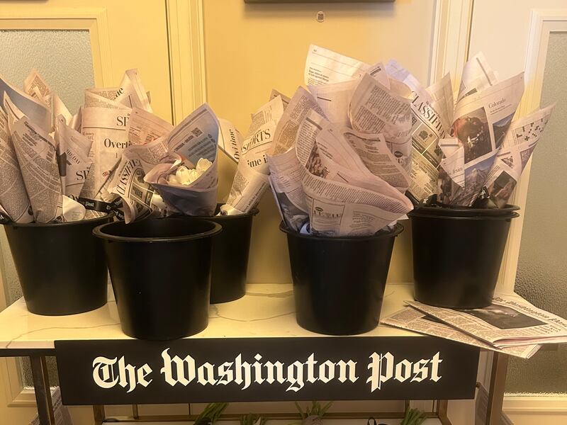 Flowers wrapped in copies of The Washington Post