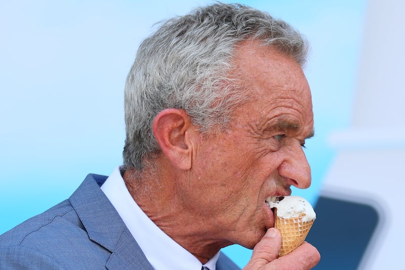 WASHINGTON, DC - JULY 14: Health and Human Services (HHS) Secretary Robert F. Kennedy Jr. eats a mint chocolate chip ice cream cone during a press conference on the steps of the United States Department of Agriculture on July 14, 2025 in Washington, DC. HHS Secretary Kennedy Jr. held a press conference along with U.S. Secretary of Agriculture Brooke L. Rollins, U.S. Commissioner of the Food and Drug Administration Dr. Martin A. Makary, President & CEO of International Dairy Foods Association Michael Dykes and CEO of Turkey Hill Andy Jacobs as they announced that ice cream makers who are responsible for 90% of the nation’s ice cream and frozen dairy desserts are pledging to eliminate many artificial food dyes by the end of 2027, the move aligns with Kennedy Jr.'s "Make America Healthy Again" platform. Dr. Makary also stated that the FDA will soon approve a new blue food dye made from gardenia fruit. (Photo by Michael M. Santiago/Getty Images)