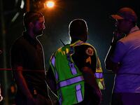 Law enforcement officers talk to each other as they work after reports of shots fired outside Donald Trump's golf club in West Palm Beach, Florida.