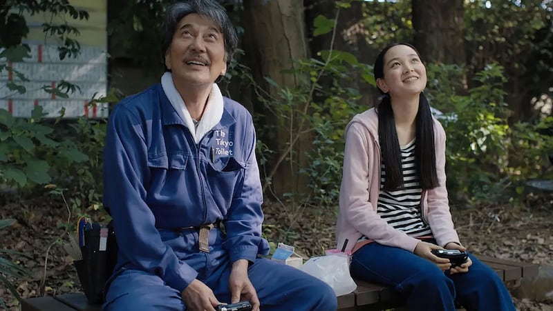 Koji Yakusho and Arisa Nakano sit next to each other in a still from 'Perfect Days'