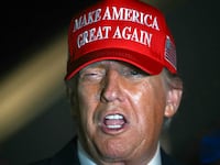 Donald Trump talks to journalists as he arrives at Joint Base Andrews, Maryland early on July 4, 2025.