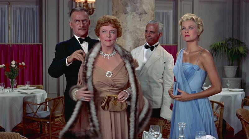 Princess Diana’s Cannes dress was inspired by the one Grace Kelly wore in the 1955 movie “To Catch a Thief.” Pictured here with John Williams and Jessie Royce Landis.