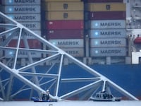 Emergency diver teams work at the site of the wreckage of the Dali cargo vessel, which crashed into the Francis Scott Key Bridge causing it to collapse, in Baltimore, Maryland, U.S., March 27, 2024.