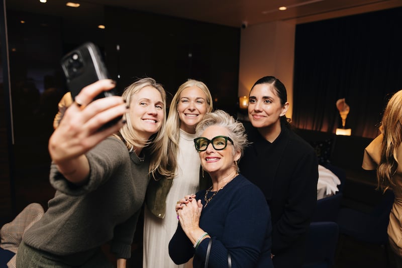 Guests snap a group selfie with Laurie Dowley (second from right).