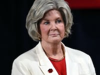 White House Chief of Staff Susie Wiles (L) listens to US President Donald Trump speaking during a campaign rally at F&M Bank Arena in Clarksville, Tennessee on October 10, 2026. Trump is campaigning for Republican candidates ahead of the November 3 midterm election.