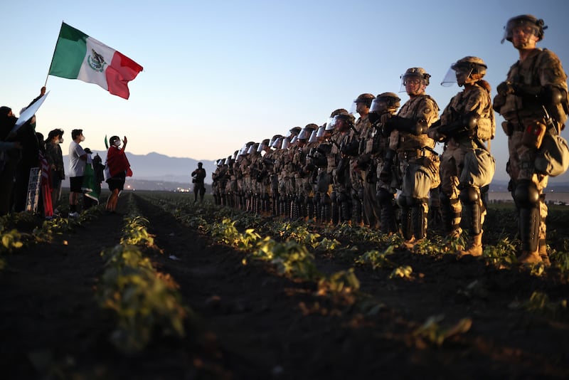 CAMARILLO, CALIFORNIA - JULY 10: National Guard soldiers block protestors during an ICE immigration raid at a nearby cannabis farm on July 10, 2025 near Camarillo, California. Protestors stood off with federal agents for hours outside the farm in the farmworker community in Ventura County. A Los Angeles federal judge is set to rule Friday on a temporary restraining order which would restrict area immigration enforcement operations. (Photo by Mario Tama/Getty Images)