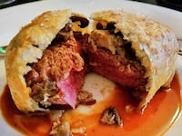 Beef wellington on a plate, with mushrooms