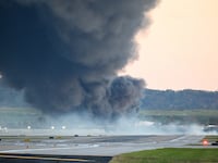 Fire and smoke mark where a UPS cargo plane crashed near Louisville Muhammad Ali International Airport on November 04, 2025 in Louisville, Kentucky.