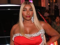 NeNe Leakes poses in a red dress at a birthday party in Georgia