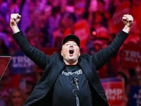 TOPSHOT - Tesla and SpaceX CEO Elon Musk gestures as he steps on stage during a rally for former US President and Republican presidential candidate Donald Trump at Madison Square Garden in New York, October 27, 2024.