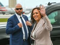 US Vice President Kamala Harris waves while walking to her vehicle