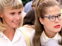Olivia Newton-John as Sandy Olsen, left, and Susan Buckner (wearing cat's eyes glasses) as Patty Simcox.