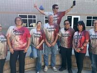 Teachers seen with blood-stained 'Problem Solved' T-shirts.