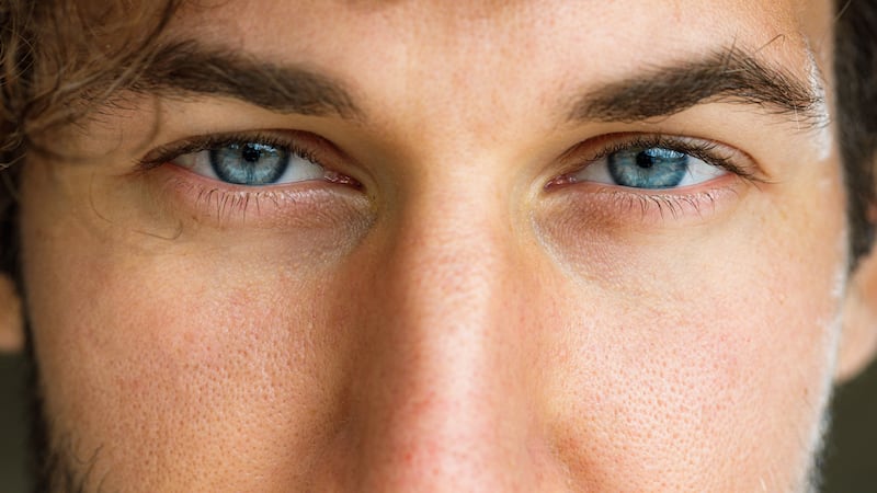 Close up of man's blue eyes looking at camera