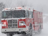 Firefighters respond to a call as snow continues to fall in Truckee, Calif., on Saturday, March 2, 2024.