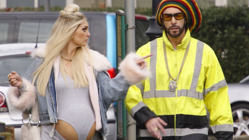 (L to R) Morgana Robinson as Julie and Sacha Baron Cohen as Ali G in ALI G: WHO IZ I?, from Amazon MGM Studios.
Photo Credit: Courtesy of Amazon MGM Studios
© 2026 Amazon Content Services LLC. All Rights Reserved.