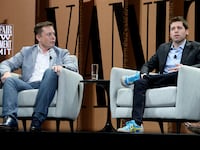 Elon Musk and Sam Altman speak together at a panel forum in San Francisco in 2015.