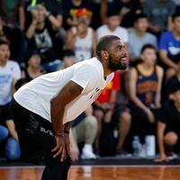 NBA player Kyrie Irving reacts during a promotional event in Taipei.