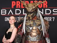 LOS ANGELES, CALIFORNIA - NOVEMBER 03: (L-R) Elle Fanning poses with 'Father' at the premiere of Predator: Badlands at TCL Chinese Theater on November 03, 2025 in Los Angeles, California. (Photo by Jesse Grant/Getty Images for 20th Century Studios)