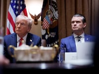 Donald Trump and Pete Hegseth appear during a Cabinet meeting at the White House on Feb. 25.