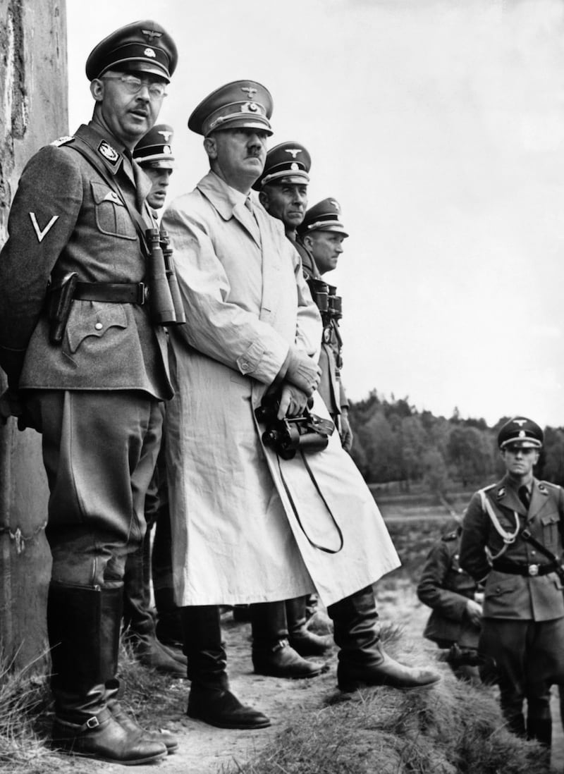 Adolf Hitler stands beside Heinrich Himmler, the head of the Gestapo, to observe a parade of Nazi Stormtroopers in 1940.