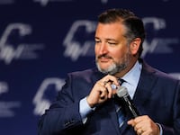 Ted Cruz photographed holding a microphone.