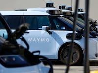 Waymo electric autonomous ride-hailing service vehicles are charged at a private charging station on September 14, 2026 in San Diego, CA.